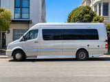 Silver Mercedes-Benz Sprinter RV rental van parked on a sunny city street.|Silver Mercedes-Benz Sprinter RV rental