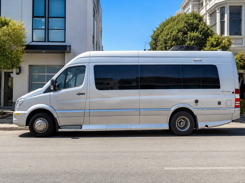 Silver Mercedes-Benz Sprinter RV rental van parked on a sunny city street.|Silver Mercedes-Benz Sprinter RV rental — photo 1