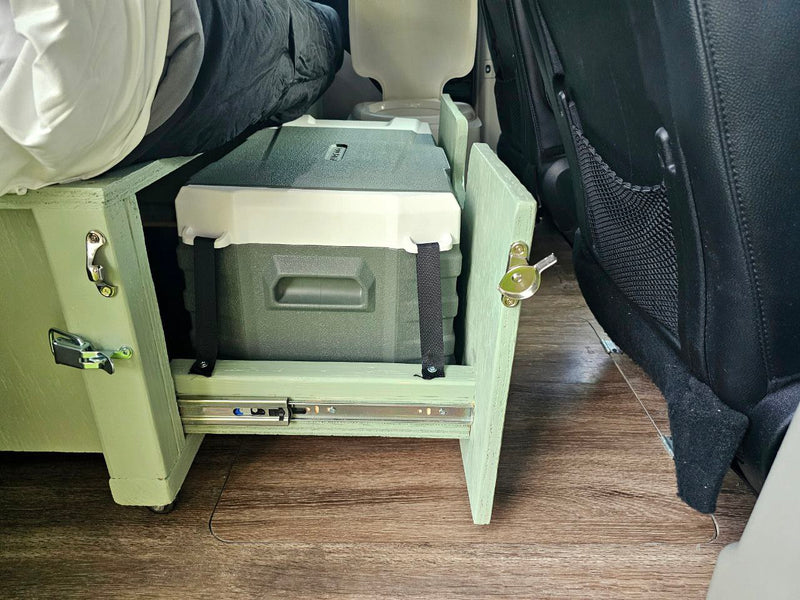 RV rental shows a custom bed base with a pull-out cooler and portable toilet, optimizing space in a van conversion. — photo 10