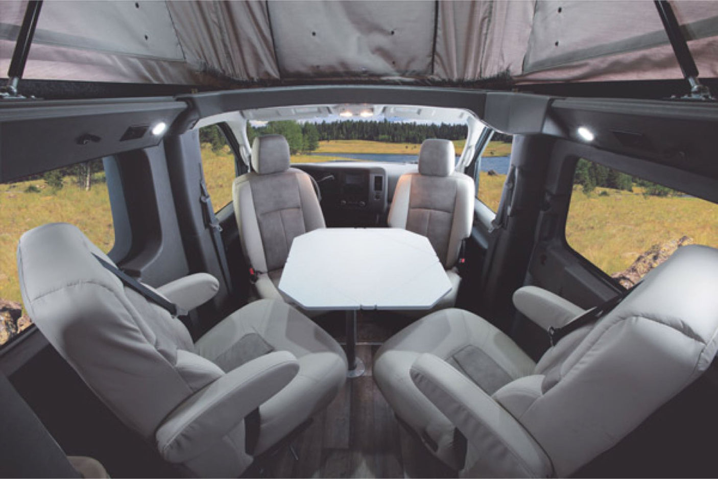  parked on a city street.|A modified silver RV rental