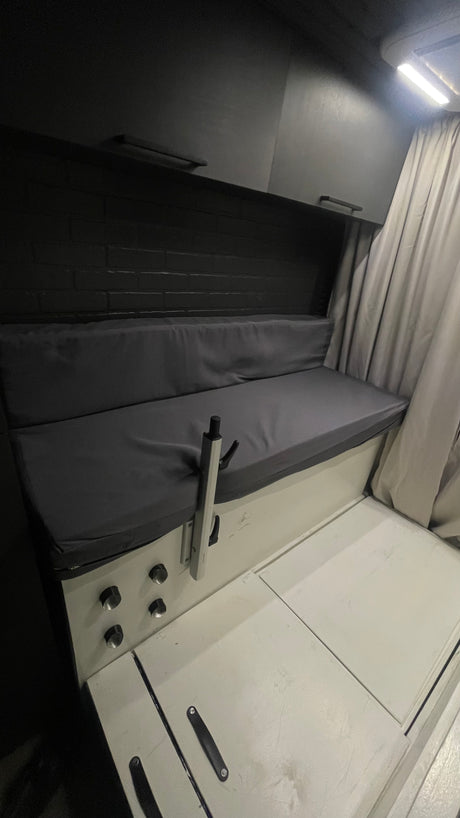 This RV rental shows a smart interior with a bench seat, overhead storage, and floor hatches for maximized space.