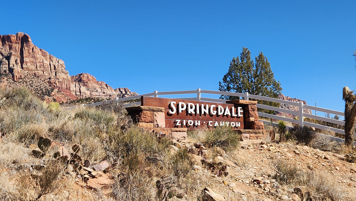 Springdale, Zion Canyon welcome sign. Start your scenic RV rental adventure near majestic red rocks of Zion National Park.