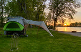 Experience serene sunset camping with this SylvanSport Go RV rental, a versatile pop-up trailer beside a tranquil lake.