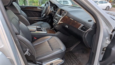 Inside a modern car: premium black leather seats, wood trim, and detailed dashboard. A comfortable option beyond typical RV rental.