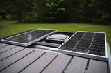 RV rental rooftop with two solar panels and a central vent, providing off-grid power.