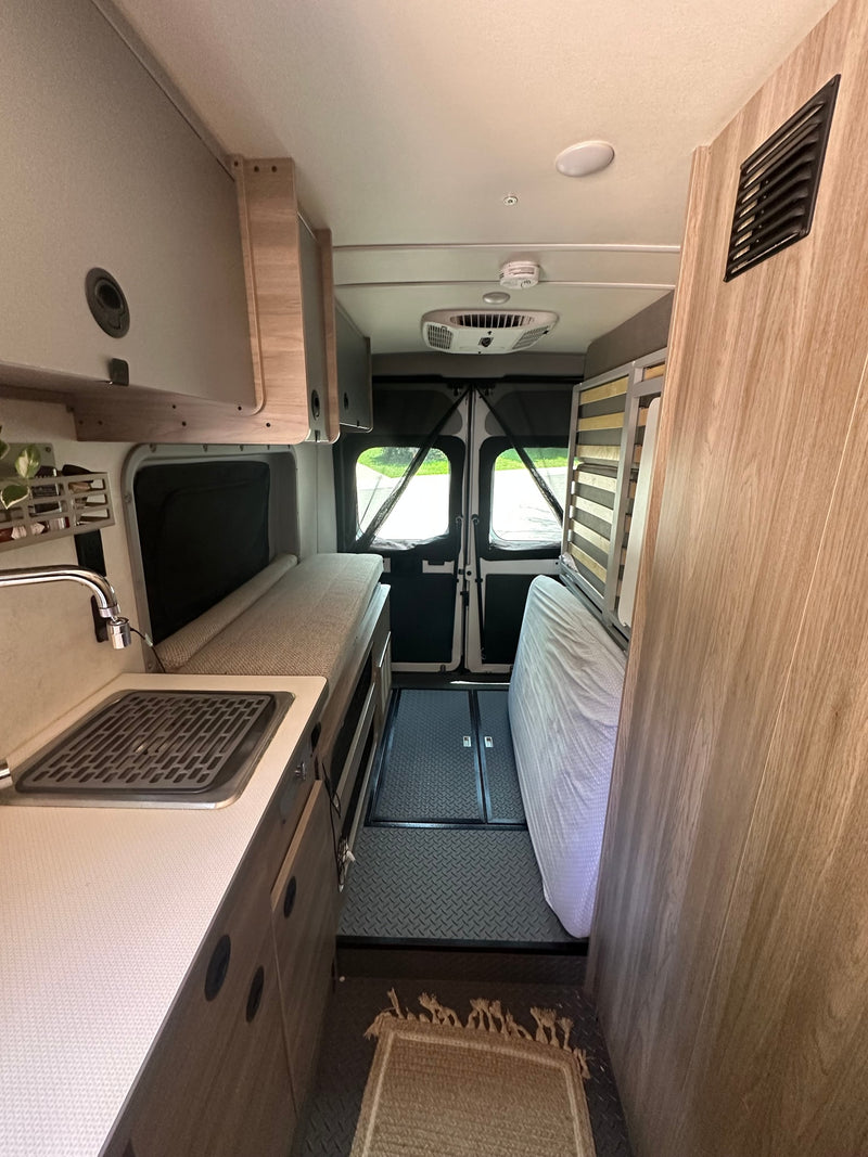 RV rental interior: kitchen with sink, convertible beds, and rear mesh doors. Perfect for comfortable mobile travel. — photo 14