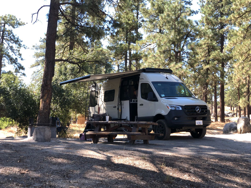  parked in a sunny desert landscape.|White Winnebago Sprinter RV rental camper van — photo 7