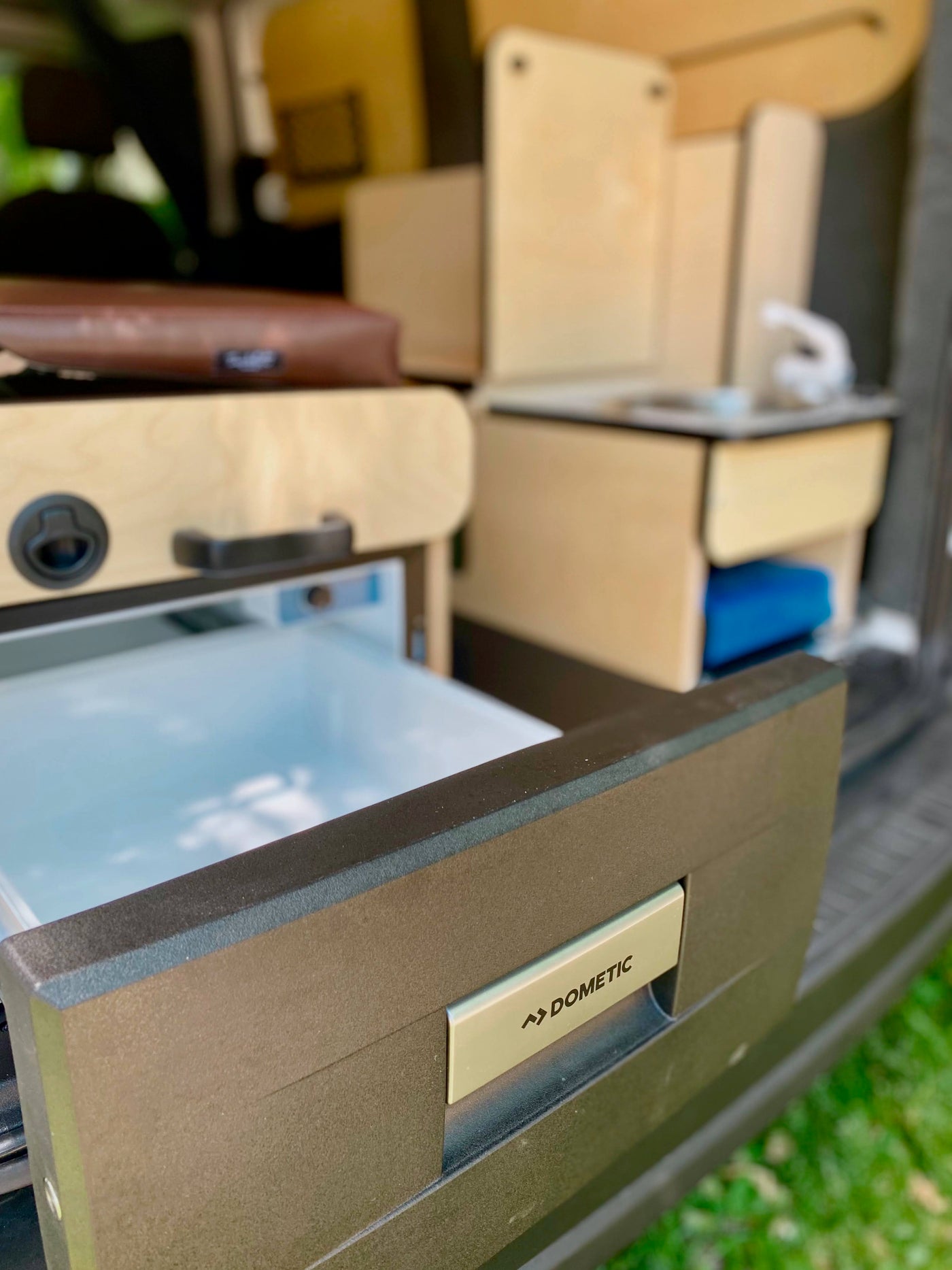 Custom RV rental interior with a pull-out Dometic fridge & wood cabinets, perfect for comfortable road trips. — photo 13