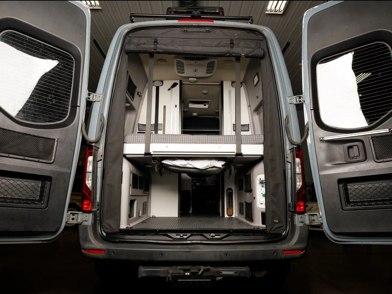  and two black leather front seats.|This RV rental camper van reveals a compact kitchen with sink — photo 11