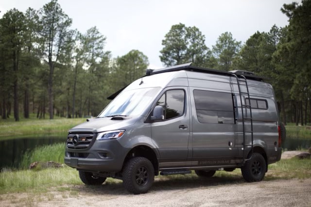 Rugged grey Mercedes-Benz Sprinter RV rental with off-road tires & roof ladder