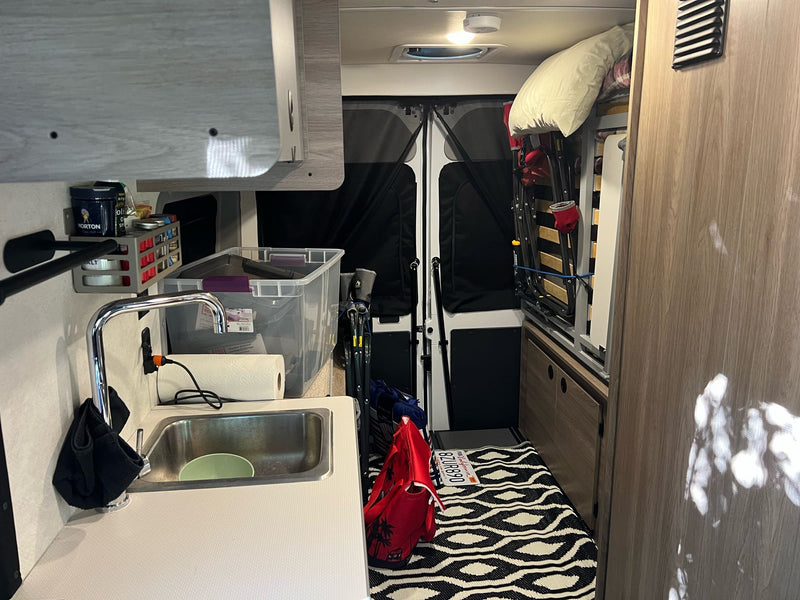  and snacks outside a cozy RV rental at golden hour — photo 7