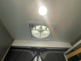 Interior of an rv rental showing a bright ceiling light and a functional roof vent fan, indicating comfort features.