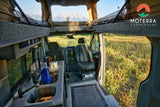 This RV rental offers a spacious interior: kitchen, swivel seats, pop-top bed, and majestic mountain views.