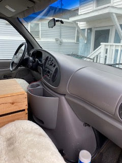 RV rental interior: Dashboard, steering wheel, and passenger space of a van, set up for road trip adventures.