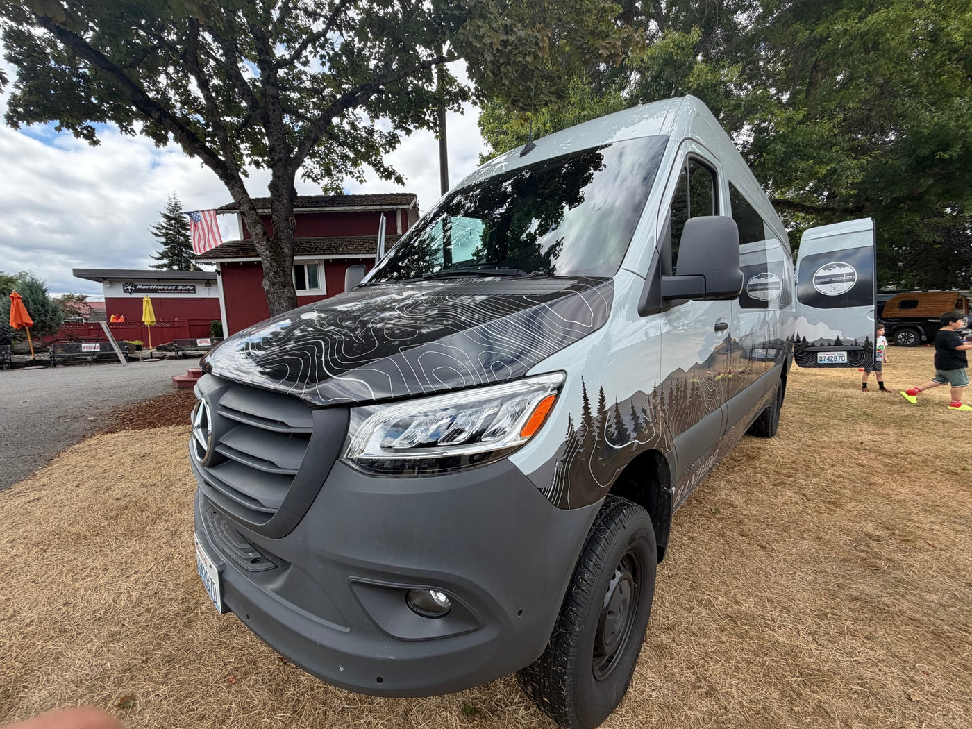  and a clear view of trees and a house outside.|Explore in style with this custom Mercedes Sprinter camper van rv rental — photo 5