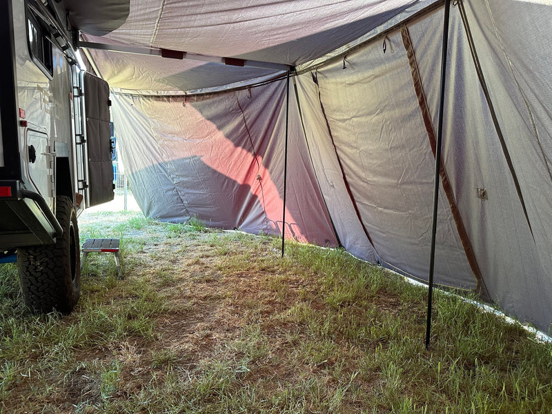 Inside a shaded RV rental annex on a grassy campsite, providing extended outdoor living space. — photo 16