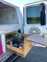 This RV rental offers compact living: a cozy bed & pull-out kitchen with all essentials for your adventures.
