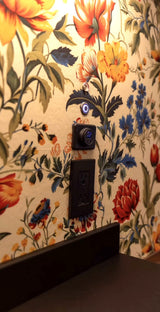 RV rental interior: Floral wall with power outlet, blue-lit dual USB charger, and control button above a dark counter.