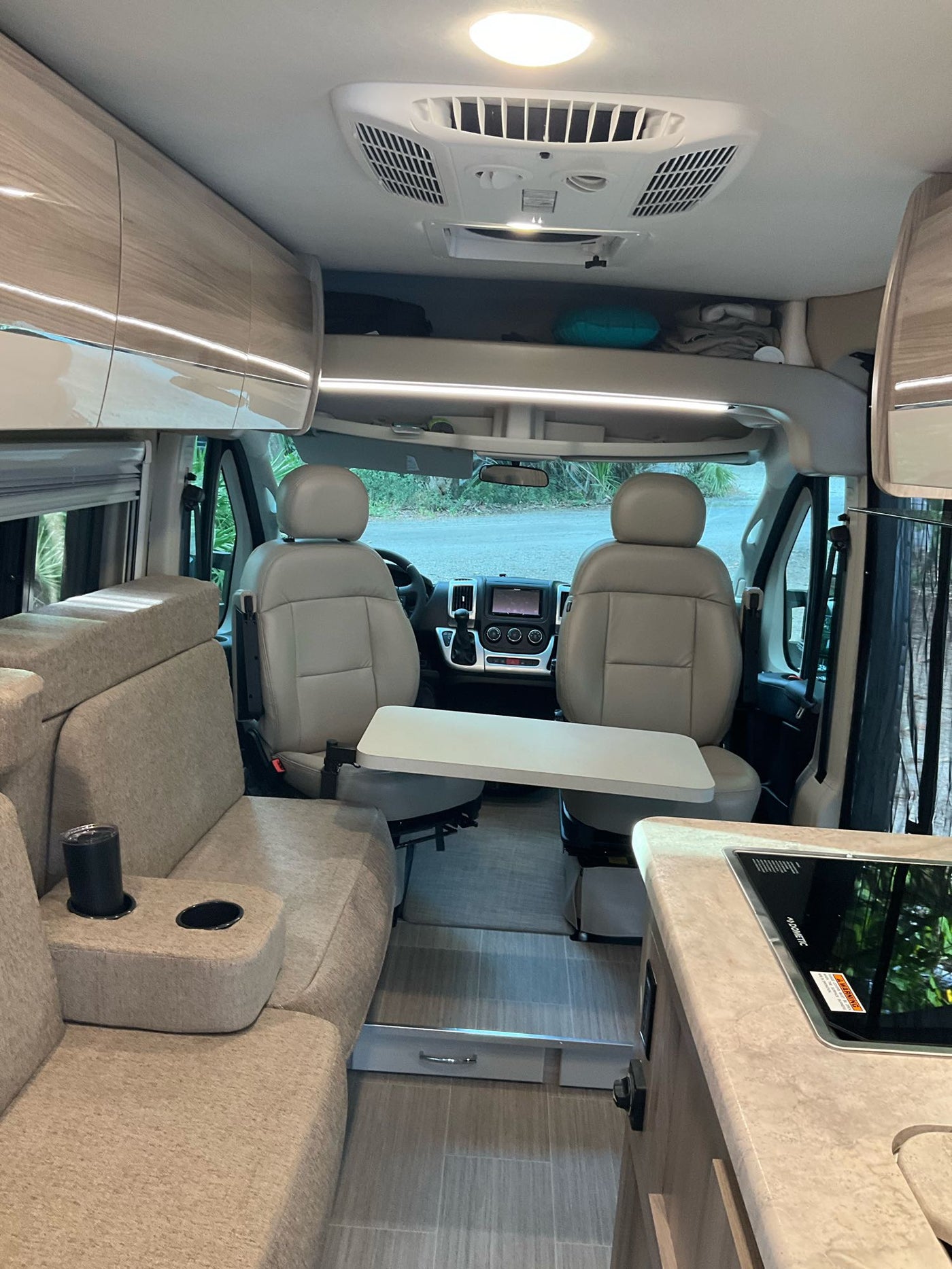  and window with outdoor views.|This RV rental's compact wet bath features a folding sink — photo 6