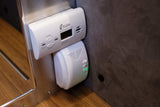 A Kidde Carbon Monoxide Alarm and small sensor with green light in an RV rental, vital for safety.