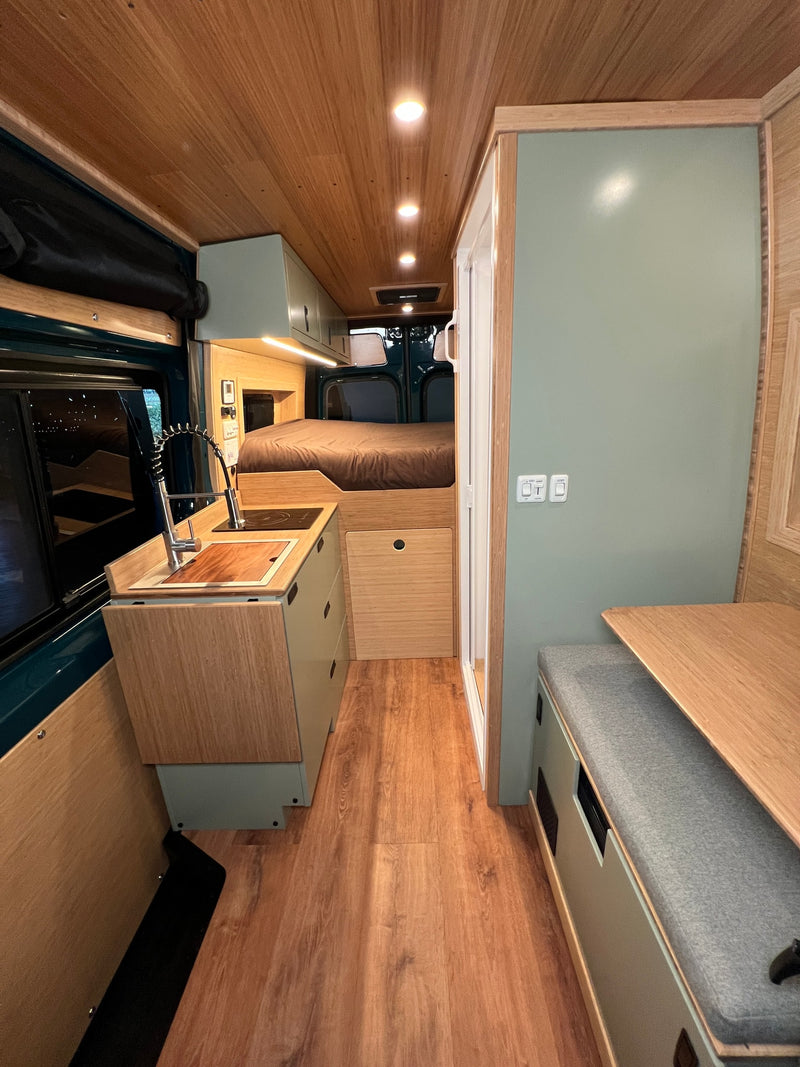  revealing storage baskets in a compact camper interior.|Inside this functional rv rental camper van: swivel seats — photo 10