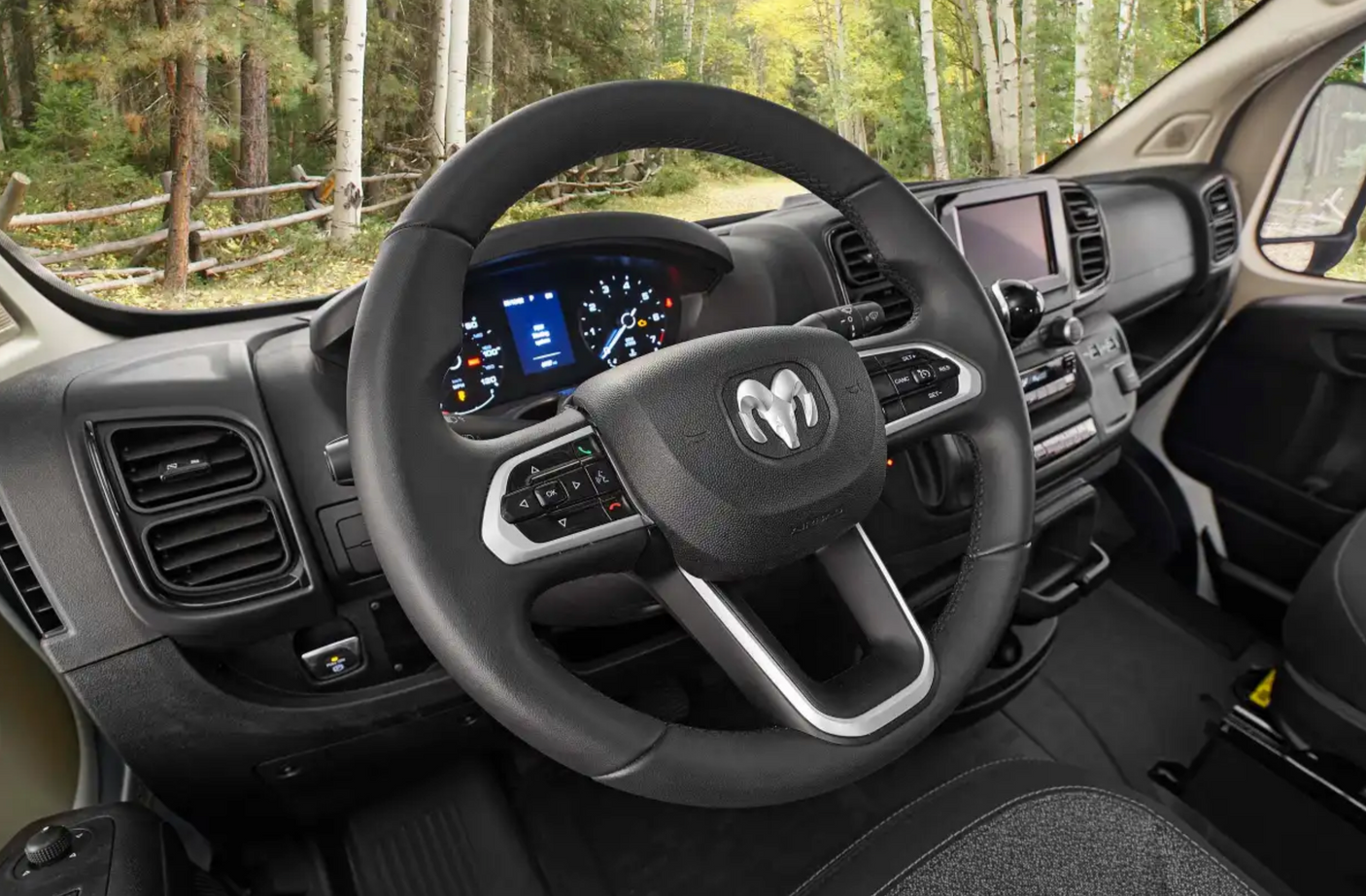 Inside a modern **RV rental** van, highlighting the Ram steering wheel, digital dashboard, and infotainment screen.