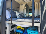 Inside your RV rental: a comfy bed, fresh water, and essential supplies in a well-organized