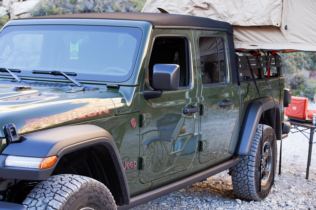 Green Jeep Gladiator pickup with rooftop tent, perfect for an off-road RV rental adventure and camping. — photo 4