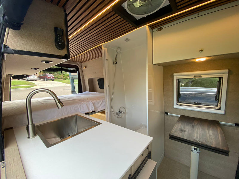  and custom wood-slatted ceiling with accent lights.|Explore this stylish RV rental interior — photo 10