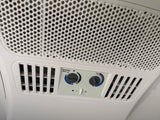  and AC unit on the ceiling.|A Dometic Evolution RV air conditioner mounted on a white RV rental roof