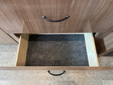 Inside an RV rental: An open drawer with a dark gray carpet liner, below a closed drawer, offering practical storage.