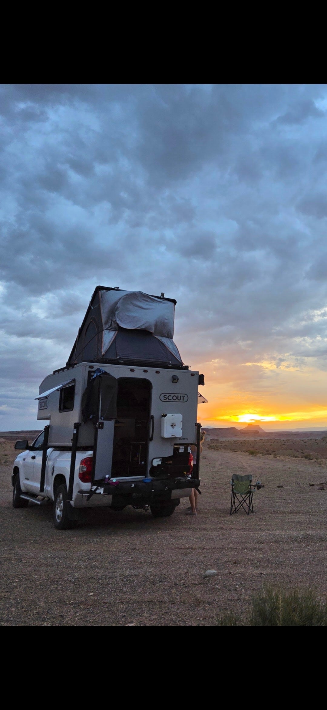 This rv rental truck camper with a rooftop tent offers epic sunset views. Perfect for camping & outdoor adventures.