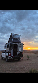 This rv rental truck camper with a rooftop tent offers epic sunset views. Perfect for camping & outdoor adventures.