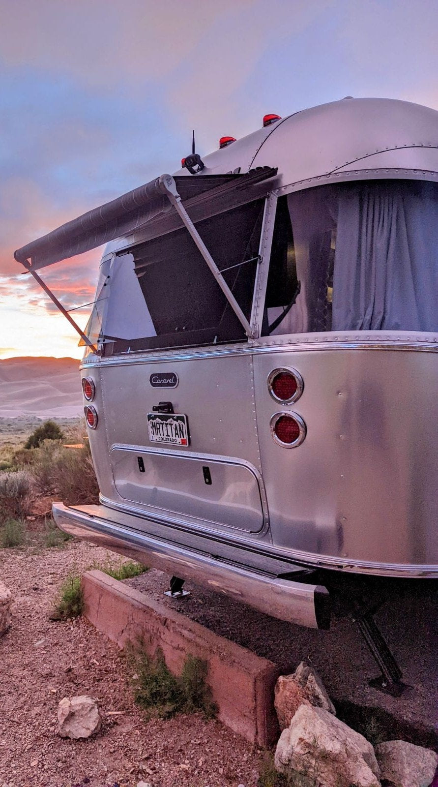  with flowers in the foreground.|An Airstream travel trailer RV rental — photo 3