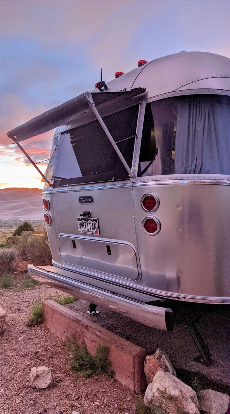  with flowers in the foreground.|An Airstream travel trailer RV rental — photo 3
