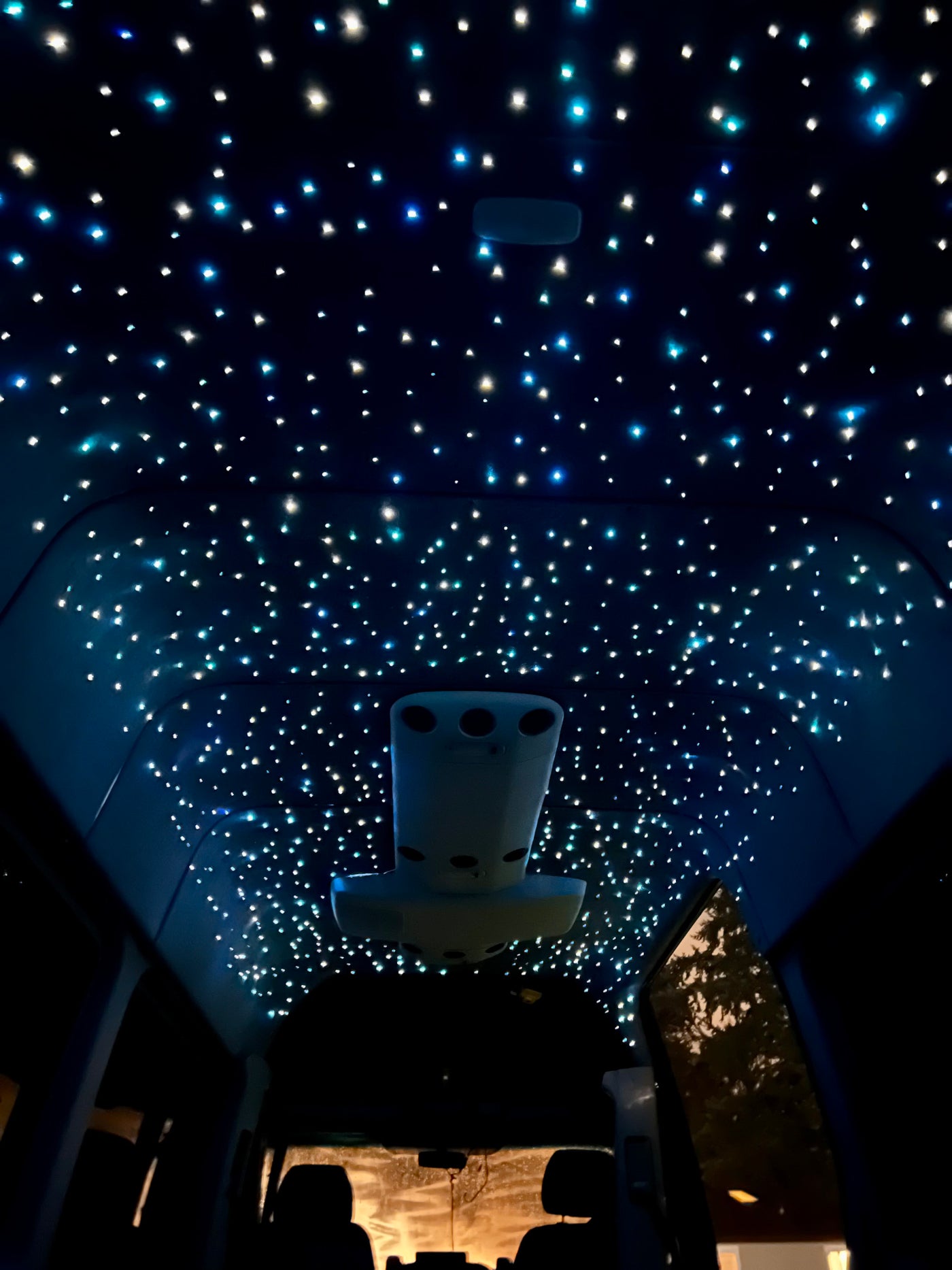 Inside an RV rental, the ceiling dazzles with a fiber optic starlight effect, creating a celestial ambiance for travelers. — photo 4