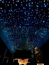 Inside an RV rental, the ceiling dazzles with a fiber optic starlight effect, creating a celestial ambiance for travelers.