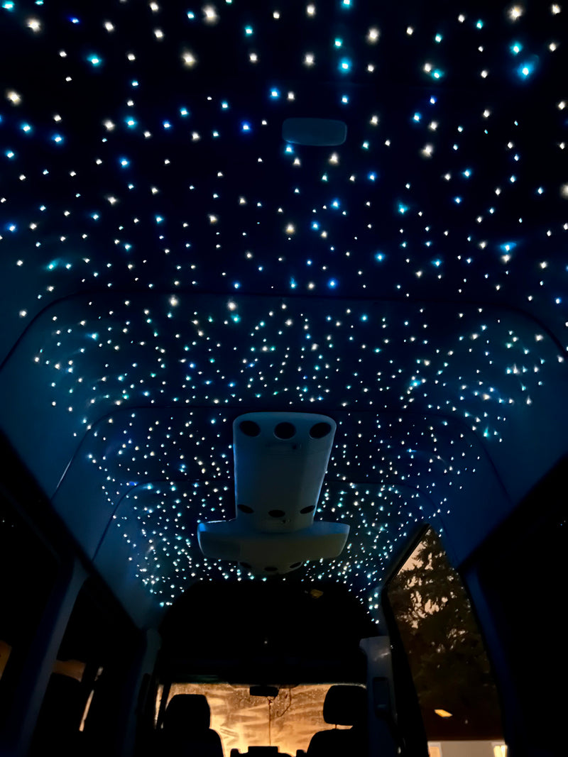 Inside an RV rental, the ceiling dazzles with a fiber optic starlight effect, creating a celestial ambiance for travelers. — photo 4