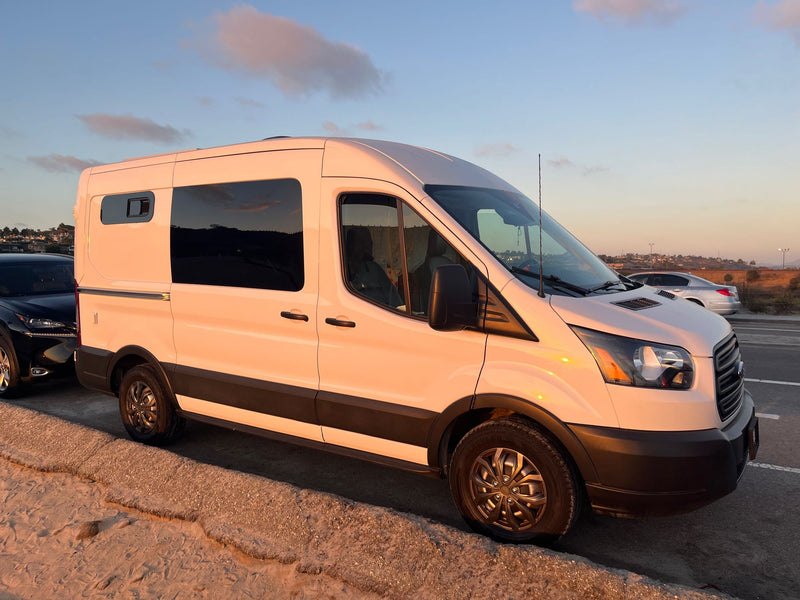  looks like an ideal rv rental for off-road adventure.|This white RV rental showcases two rooftop solar panels and a central vent system — photo 4
