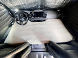 Cozy cab bed in an RV rental, featuring a Luno mattress for comfortable van camping in a Mercedes Sprinter.