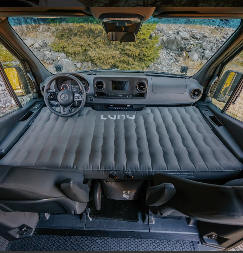  turning it into a comfortable sleeping area for adventures.|An RV rental makes pet-friendly adventures easy! A person and dog exit a Winnebago van by the water.|RV rental relaxation: High Noon Watermelon seltzer & sunglasses on a table — photo 14