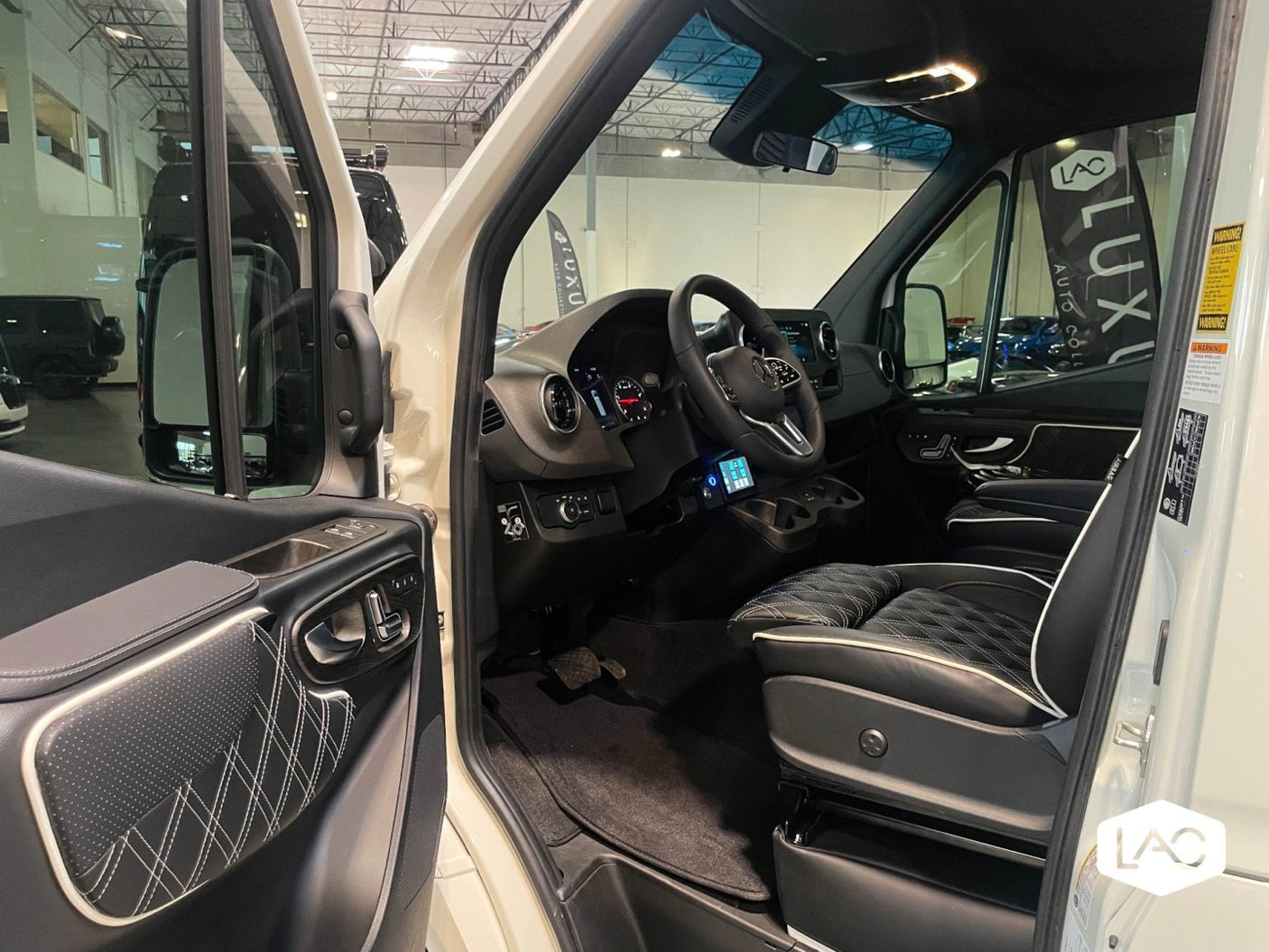 Luxury RV rental interior: inviting cab with quilted leather seating, modern dashboard, & ample space.