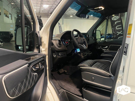 Luxury RV rental interior: inviting cab with quilted leather seating, modern dashboard, & ample space.