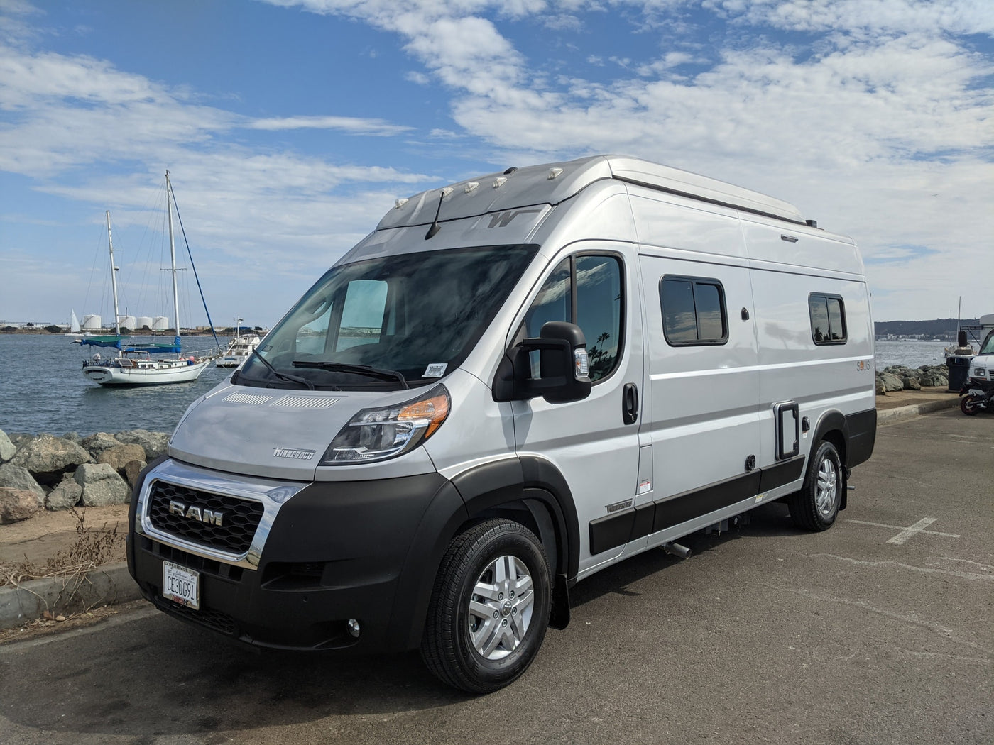 ready for your RV rental adventure.|Silver Winnebago Solis rv rental parked by a marina — photo 2