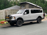  equipped with a pop-top camper & off-road gear