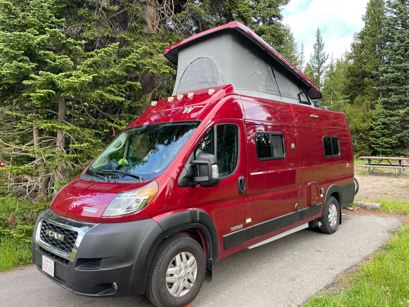  and durable textured flooring. Ideal for road trips.|RV rental wet bath features a white toilet with towels — photo 1
