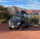 Black Mercedes Sprinter RV rental in a stunning red rock desert landscape. Ideal for your next adventure!