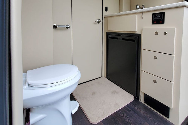  and custom amenities for premium travel comfort.|Luxurious RV rental interior with plush cream captain's chairs — photo 11