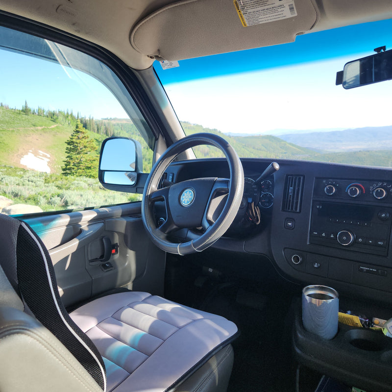 Inside an RV rental, showing the dashboard, steering wheel, and a scenic mountain view outside the window. — photo 16