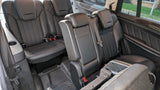 Black leather third-row seating in a spacious vehicle, ideal for an rv rental. Includes seatbelts, cup holders, and ISOFIX.